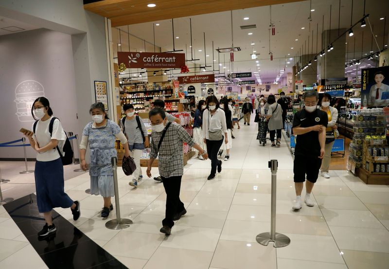Shopper walk into Japan’s supermarket group Aeon’s shopping mall as