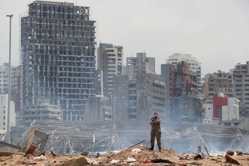 FILE PHOTO: A soldier stands at the devastated site of