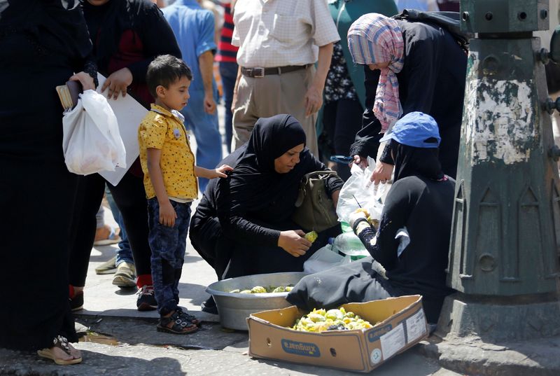 FILE PHOTO: Egyptians buy fruits from street vendor at the