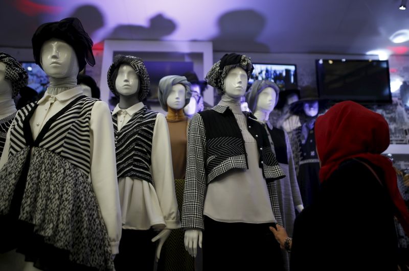 A woman looks at clothing on display at a booth