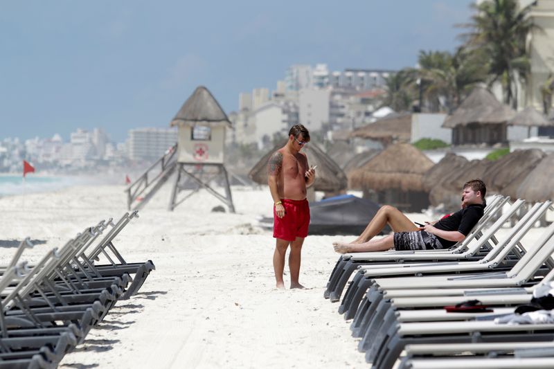 U.S. tourists relax at a beach after local authorities imposed