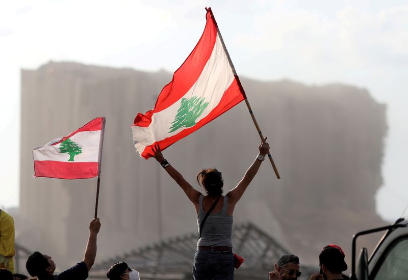 FILE PHOTO: Demonstrators wave Lebanese flags during protests near the