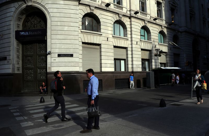 People are pictured outside a bank in Buenos Aires’ financial