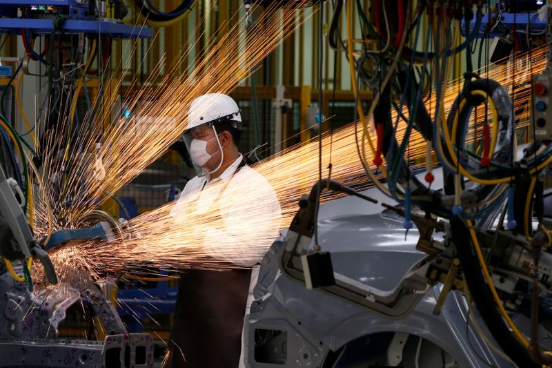 A man works in the automobile production line of the