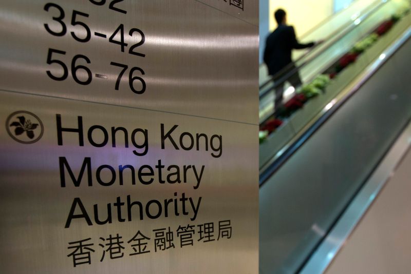 A security guard walks past a directory board of Hong