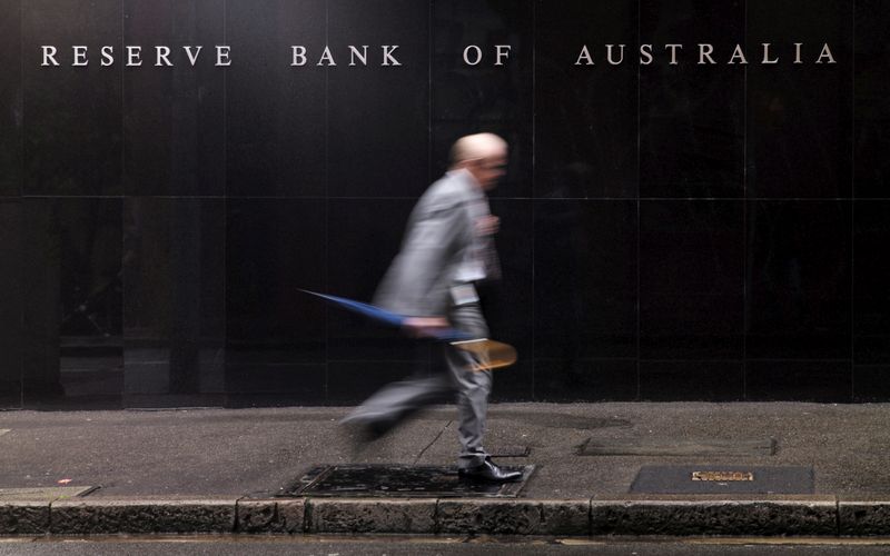 Man walks past the headquarters of Australia’s Reserve Bank in