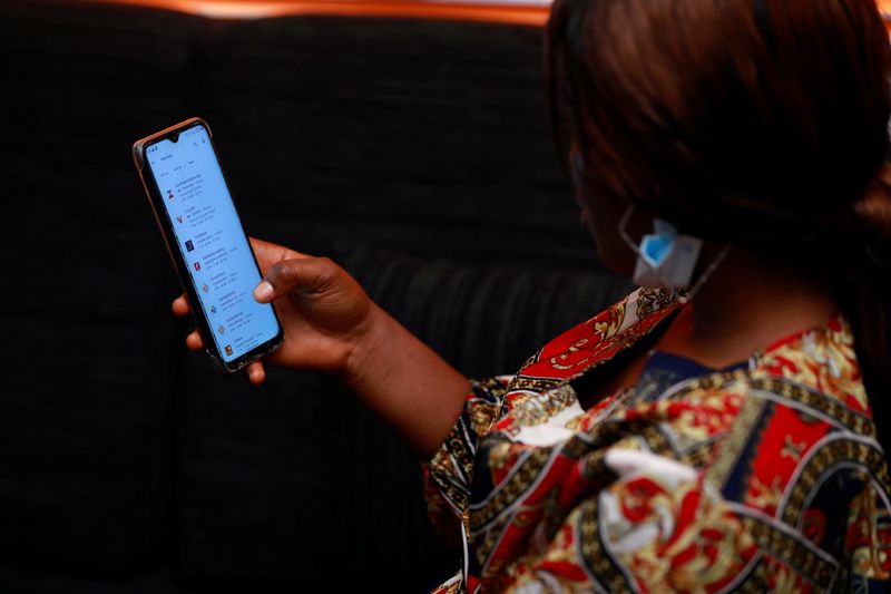 A woman looks at Nigerian banks apps on a smart
