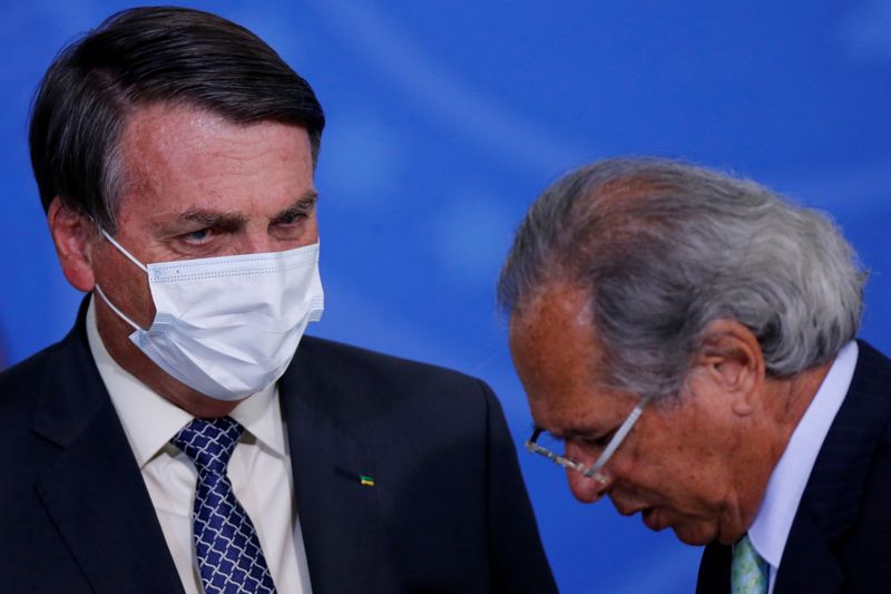 FILE PHOTO: Brazil’s President Jair Bolsonaro talks with Brazil’s Economy