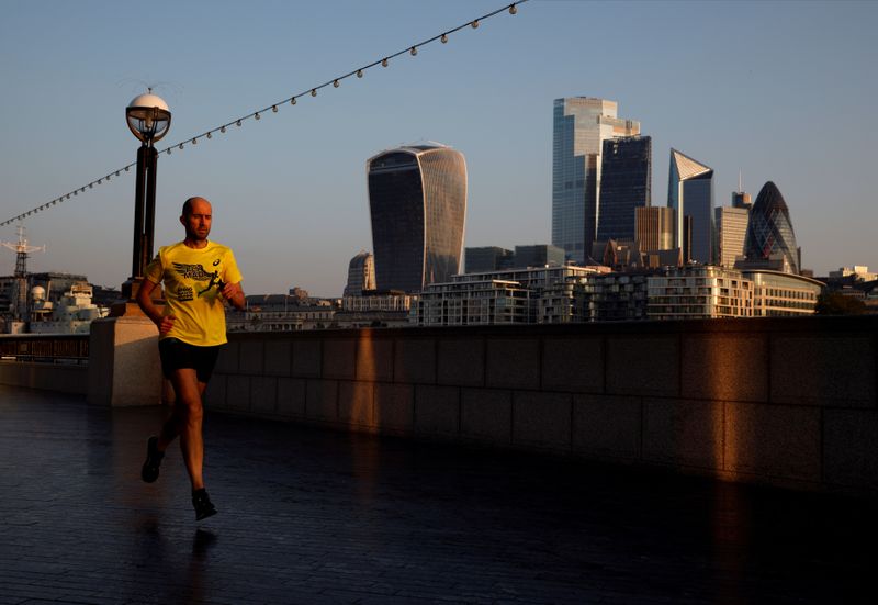 FILE PHOTO: A man runs at sunrise, with the City