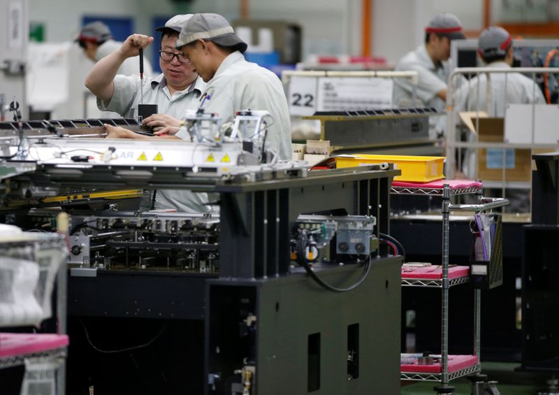 Employees are seen by their workstations at a printed circuit
