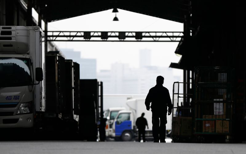 A worker walks at an industrial zone in Urayasu