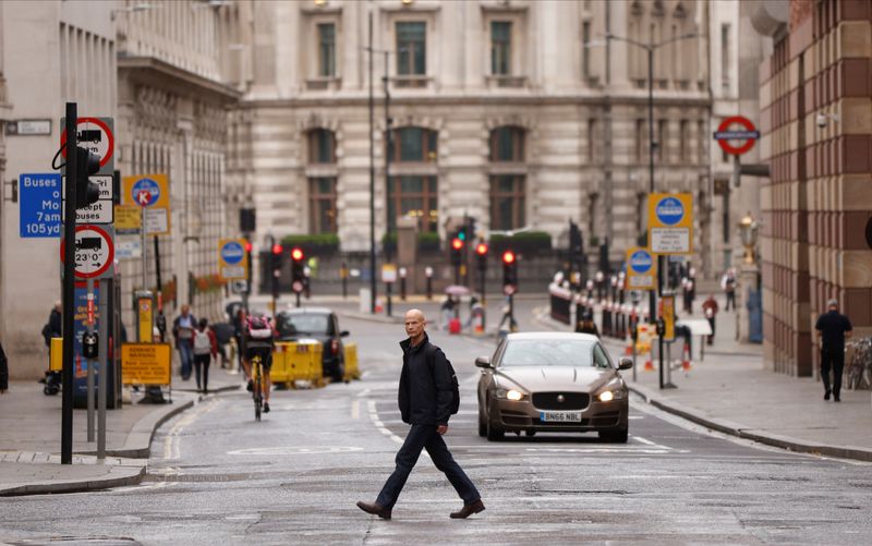 A man crosses the road in the City of London