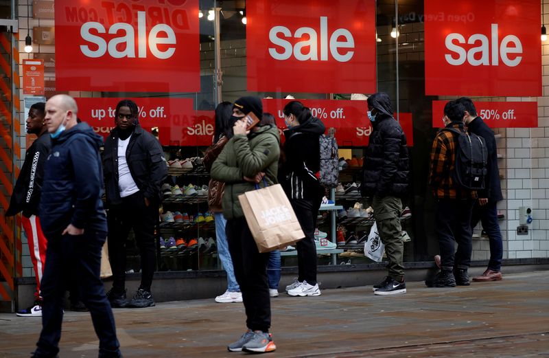 FILE PHOTO: Shoppers queue to enter a shoe shop at