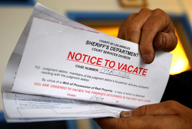 FILE PHOTO: Vicente Oliveros holds up his eviction notice in