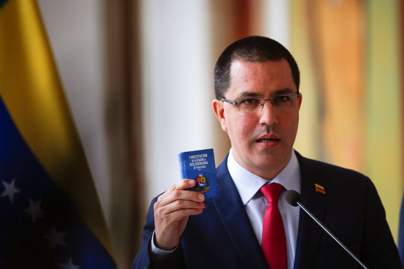 Venezuela’s Foreign Minister Jorge Arreaza holds Venezuela’s constitution as he