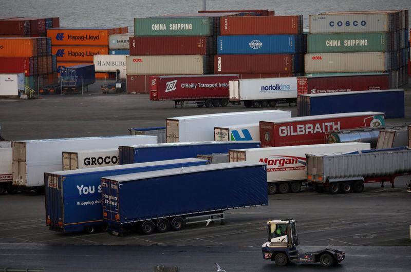 FILE PHOTO: Port vehicle drives past trailers and shipping containers