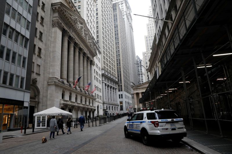 FILE PHOTO: People walk in front of the NYSE in
