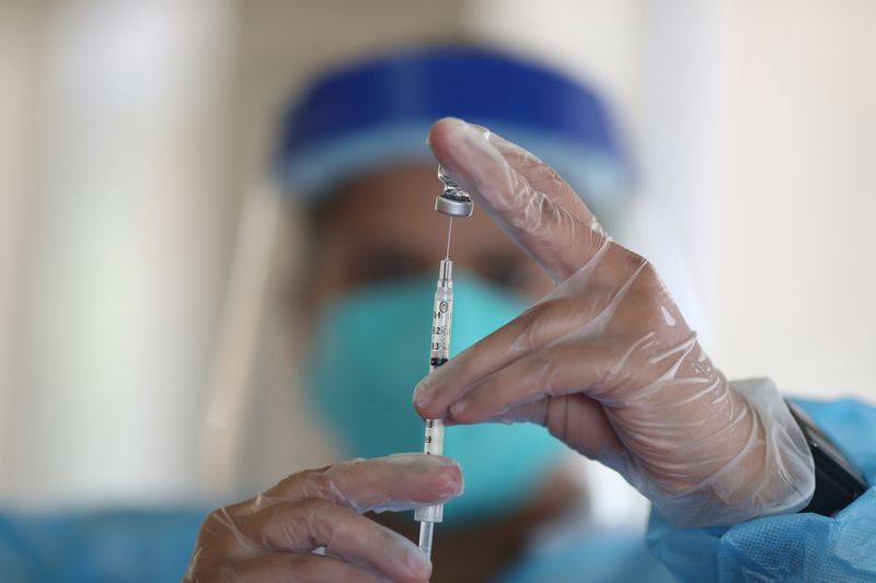 FILE PHOTO: A healthcare worker draws the coronavirus disease (COVID-19)
