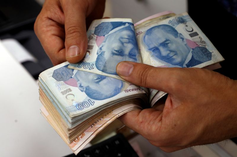 FILE PHOTO: A money changer counts Turkish lira banknotes at