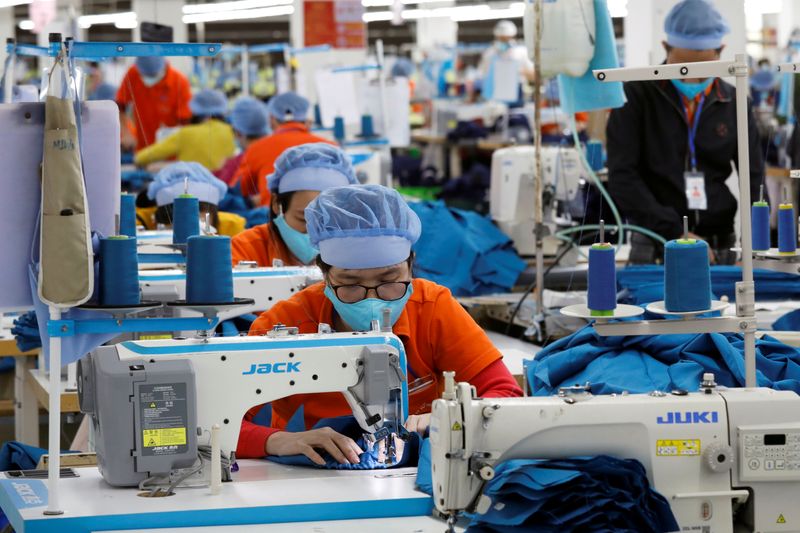 FILE PHOTO: Workers make garment products for export at a