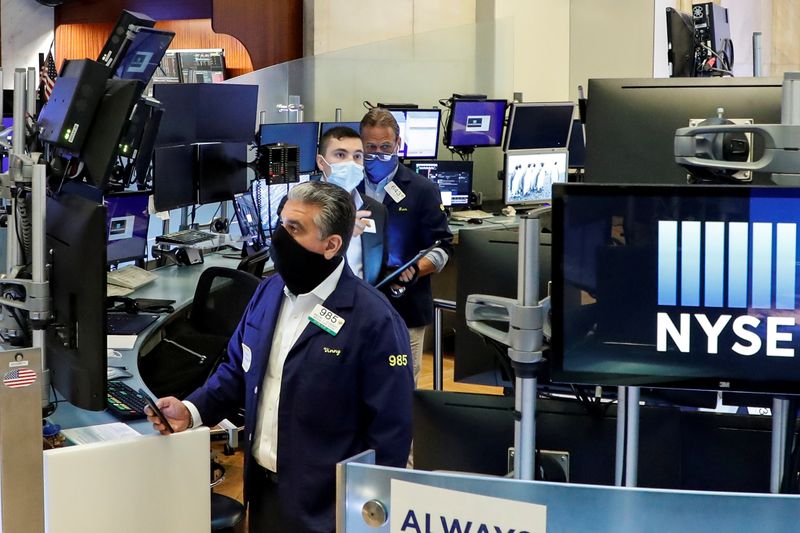 FILE PHOTO: Traders at the New York Stock Exchange during