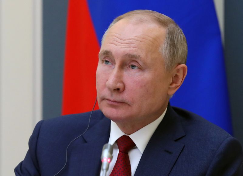 Russia’s President Putin attends a video conference during the World