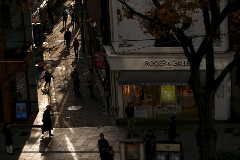 People walk at a shopping district in Tokyo
