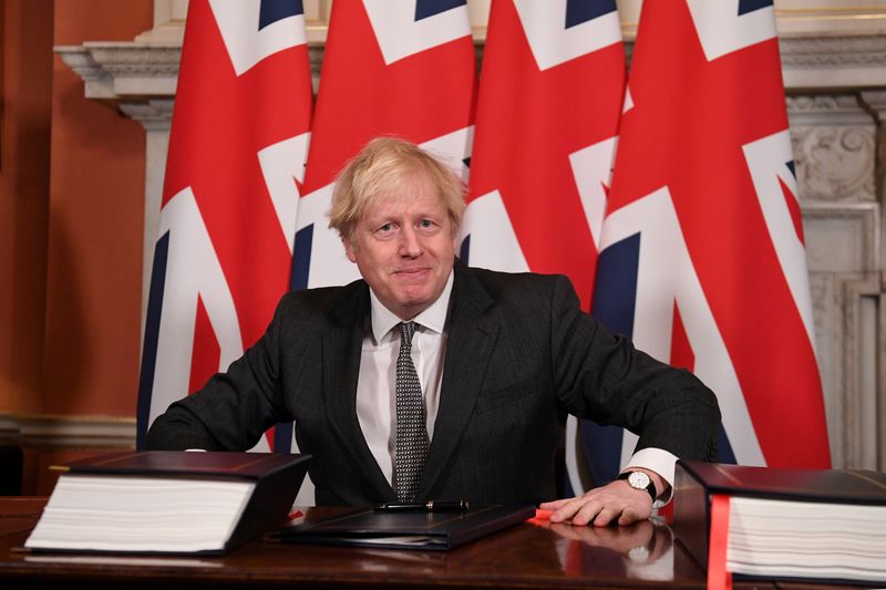 FILE PHOTO: Britain’s Prime Minister Boris Johnson signs the Brexit