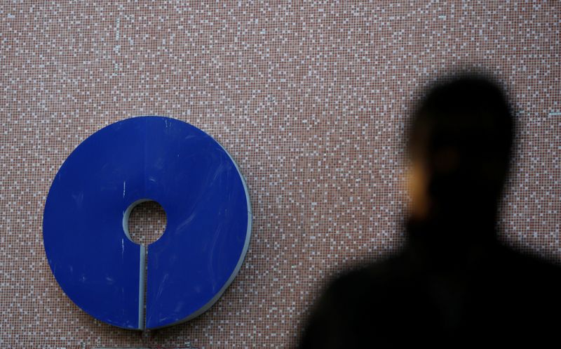 A man walks past a logo of State Bank of