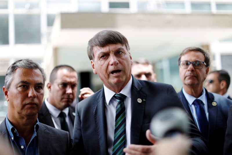 FILE PHOTO: Brazil’s President Bolsonaro talks with journalists after a