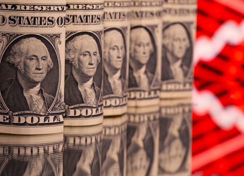 U.S. one dollar banknotes are seen in front of displayed