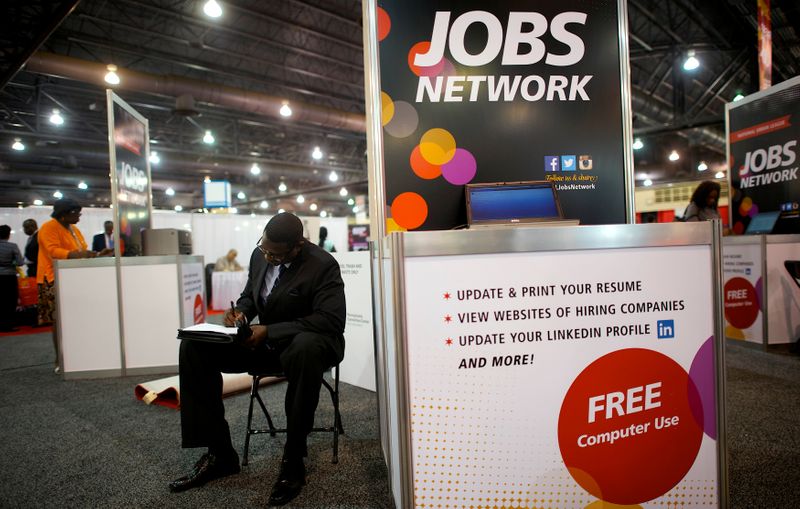 A job-seeker completes an application at a career fair in