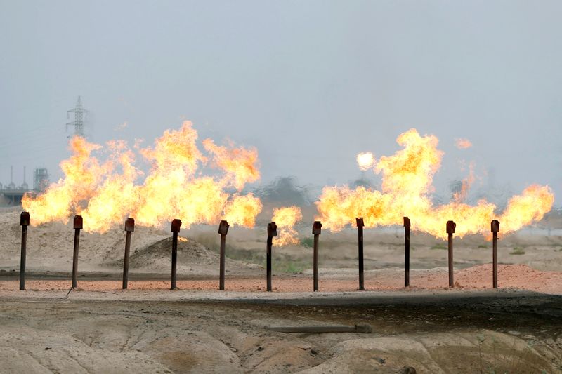 Flames are seen at a station in al-Zubair oil field,