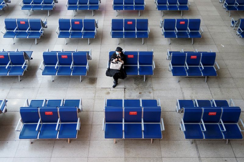 FILE PHOTO: A woman waits in the departure hall of