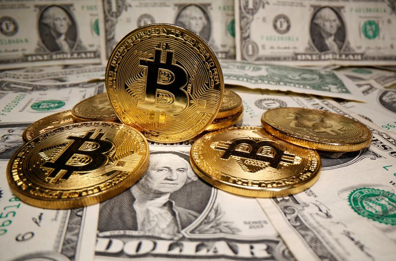 Representations of virtual currency Bitcoin are placed on U.S. Dollar