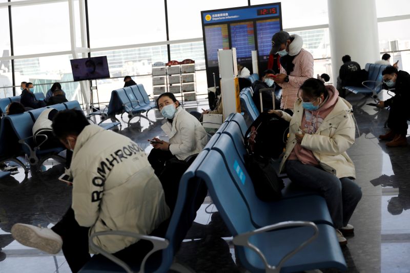 FILE PHOTO: Travellers at Wuhan Tianhe International Airport