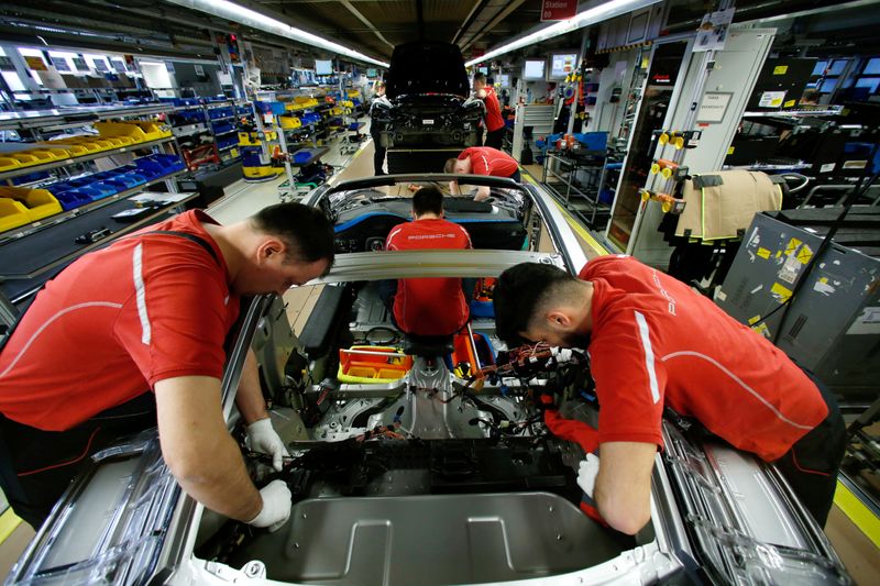 FILE PHOTO: Employees of German car manufacturer Porsche work on