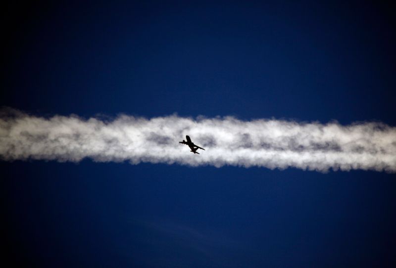FILE PHOTO:  An aeroplane flies underneath the jet stream