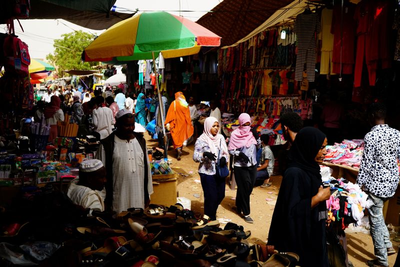 FILE PHOTO: People shop at a bazaar in Khartoum