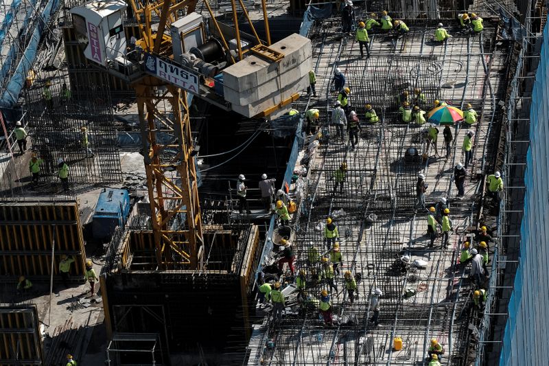 Workers work at a construction site in central Bangkok