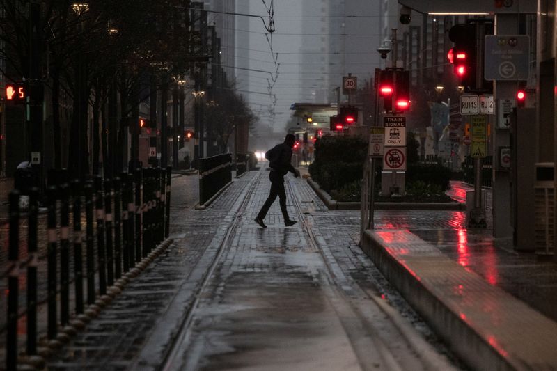 FILE PHOTO: Man crosses the street during record breaking temperatures