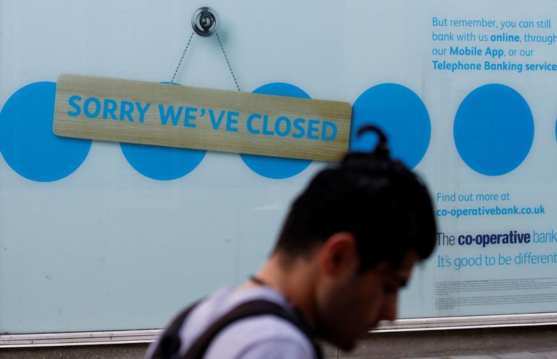 A man walks past a closed branch of the Co-Operative