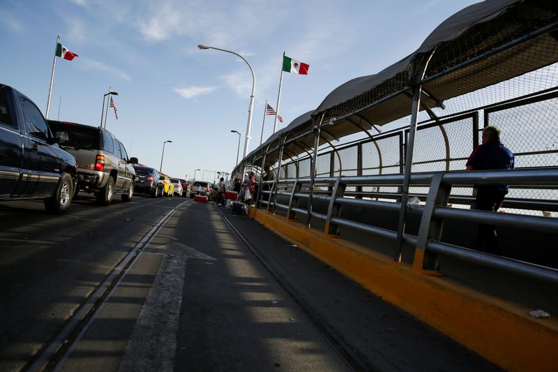 A man crosses the Paso del Norte border bridge towards