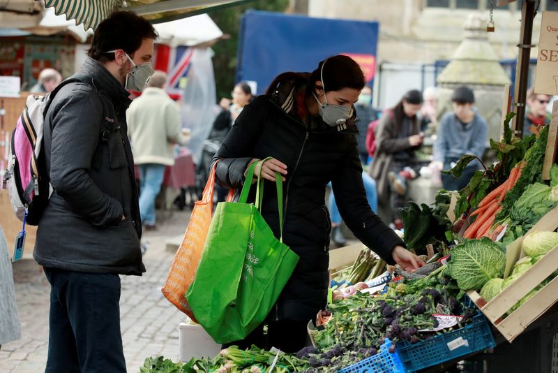 FILE PHOTO: Shoppers wearing face masks at a market in