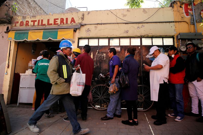 People queue to buy tortillas outside Granada market in Mexico
