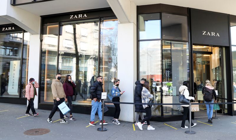 FILE PHOTO: Shoppers queue in front of a re-opened Zara
