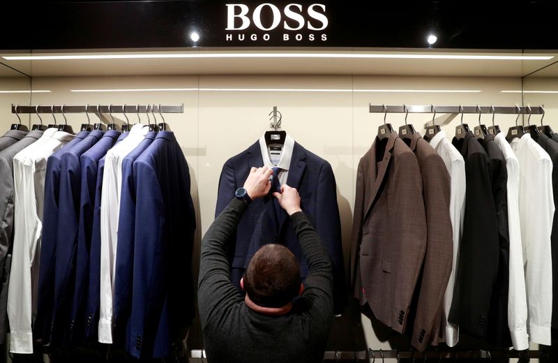 FILE PHOTO: An employee displays suits at the Hugo Boss