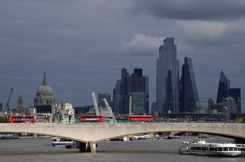 London buses cross Waterloo Bridge as St Paul’s Cathedral is