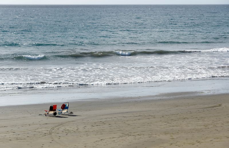 FILE PHOTO: Two empty beach chairs are photographed at San