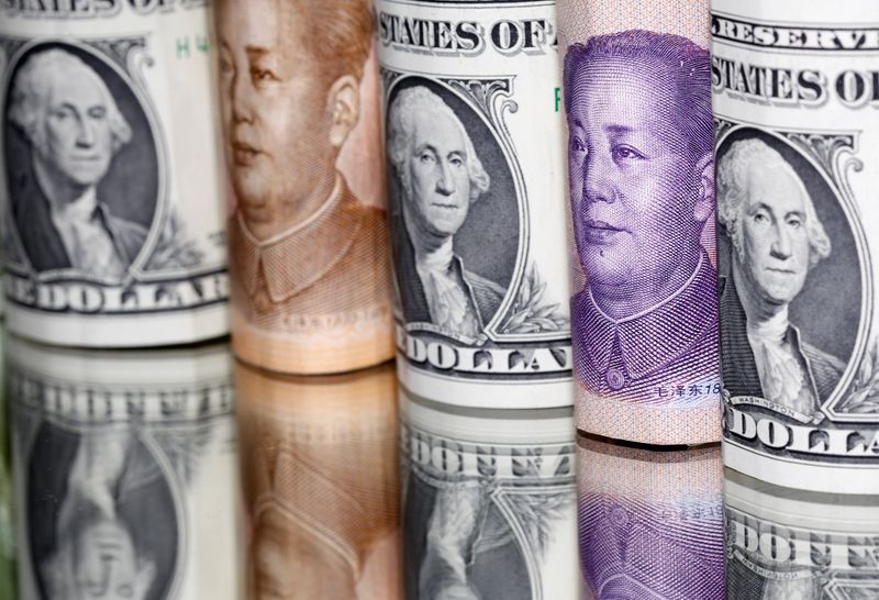 Chinese Yuan and U.S. dollar banknotes are seen in this